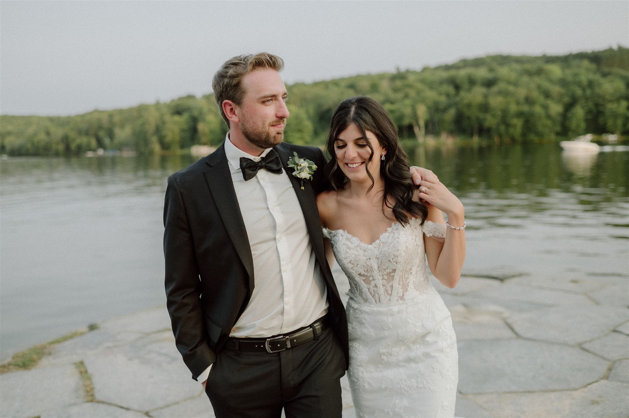 A bride and groom enjoy the sunset during their Muskoka wedding