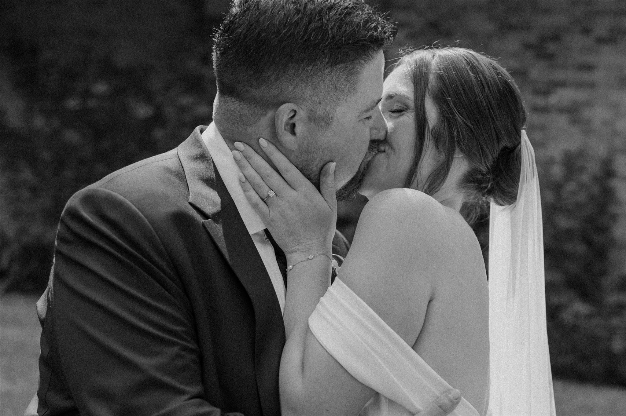 Bride and groom share a kiss at the wedding at Stonewall Estate.
