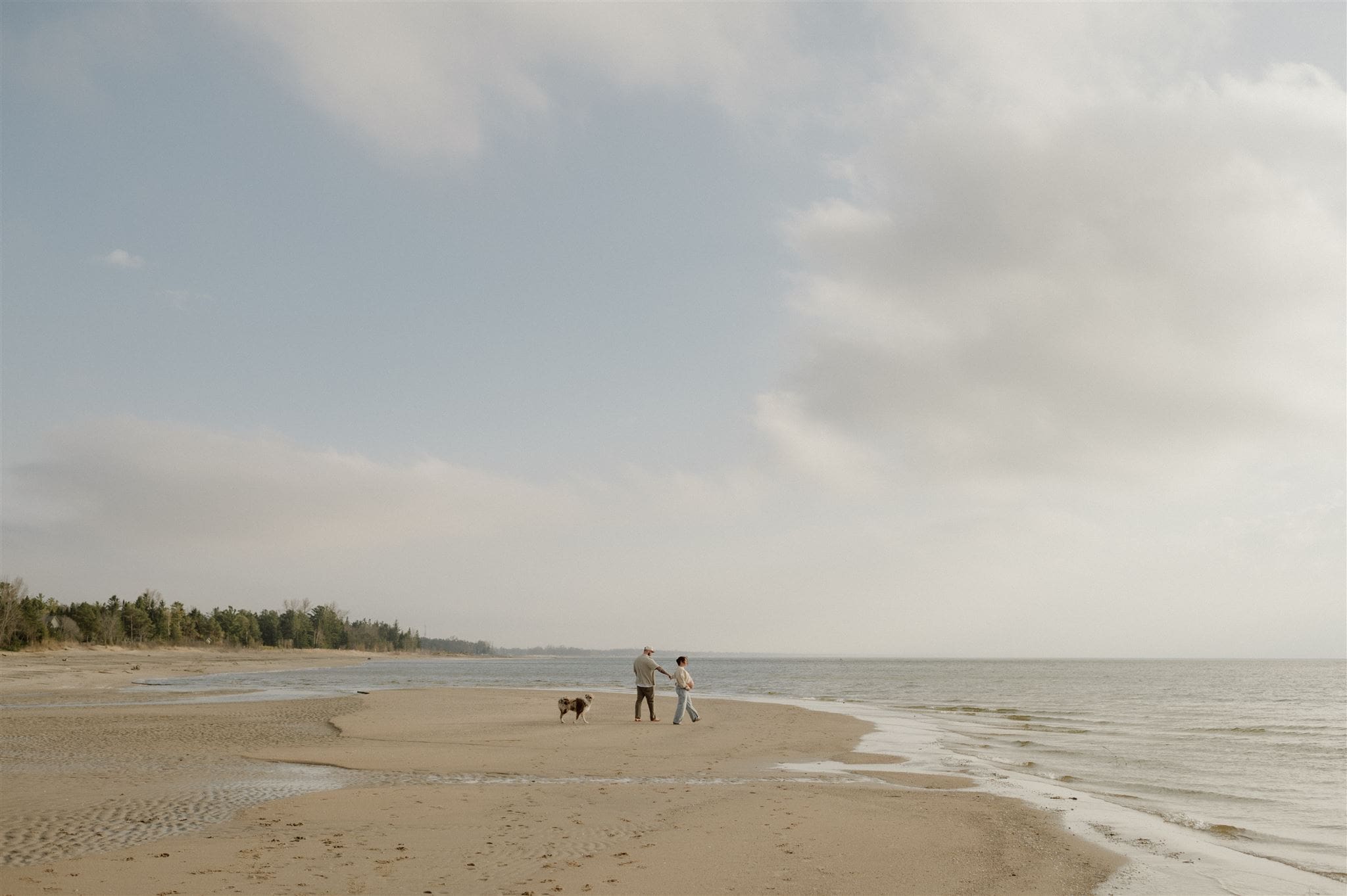 Couple on a beach in Tiny ON during their maternity session.